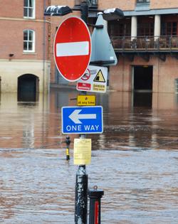 Street sign in a flooded town centre, image by Shutterstock