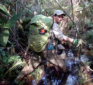 Eleonora on fieldwork in a flooded Paraguayan forest Woman with backpack in a forest