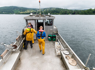 Scientists aboard a metal boat