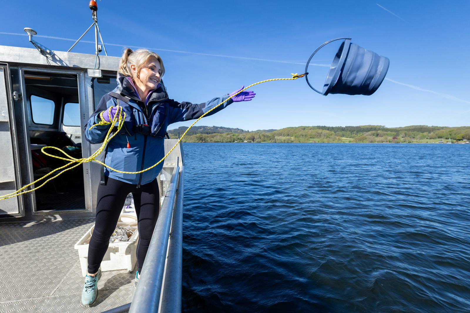 Helen Skelton on a boat collecting a water sample from Windermere for UKCEH lake science