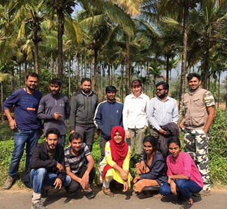 Sarah, third from right on the back row, with colleagues in India Group of people in front of trees