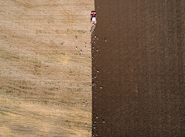 Tractor ploughing. Photo copyright Simon Butterworth. Aerial shot of a tractor ploughing a field