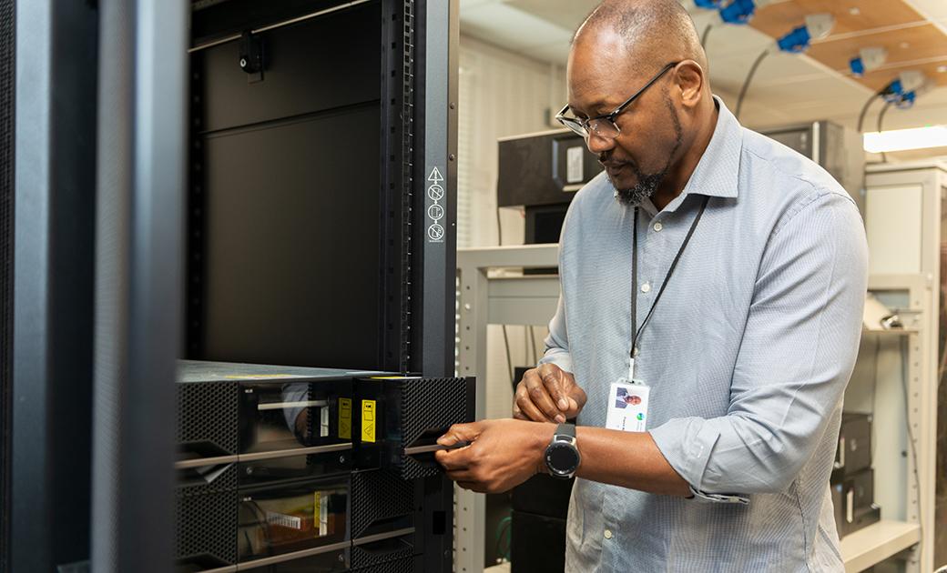 Franck Mpinda working in the UKCEH server room in Wallingford