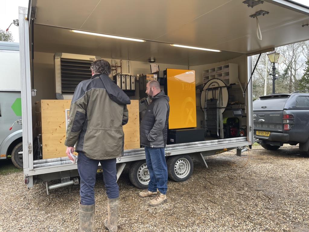 Couple of people in front of a trailer