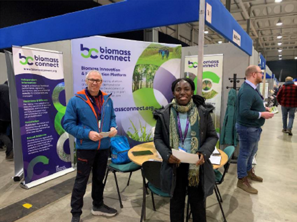 two people next to ag show stand