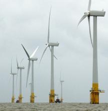 Row of 5 wind turbines in the sea