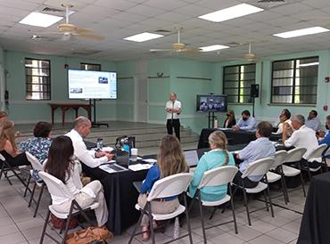 Participants in a meeting looking at a presentation