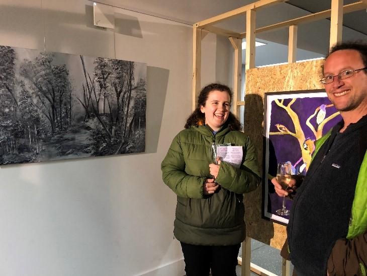 Catherine pictured beside her painting at the exhibition