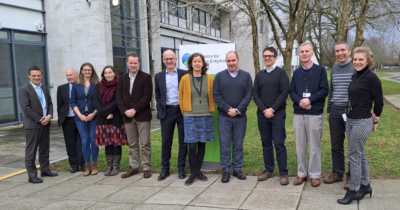 Group of 12 people from UKCEH and Met Office standing outside UKCEH offices