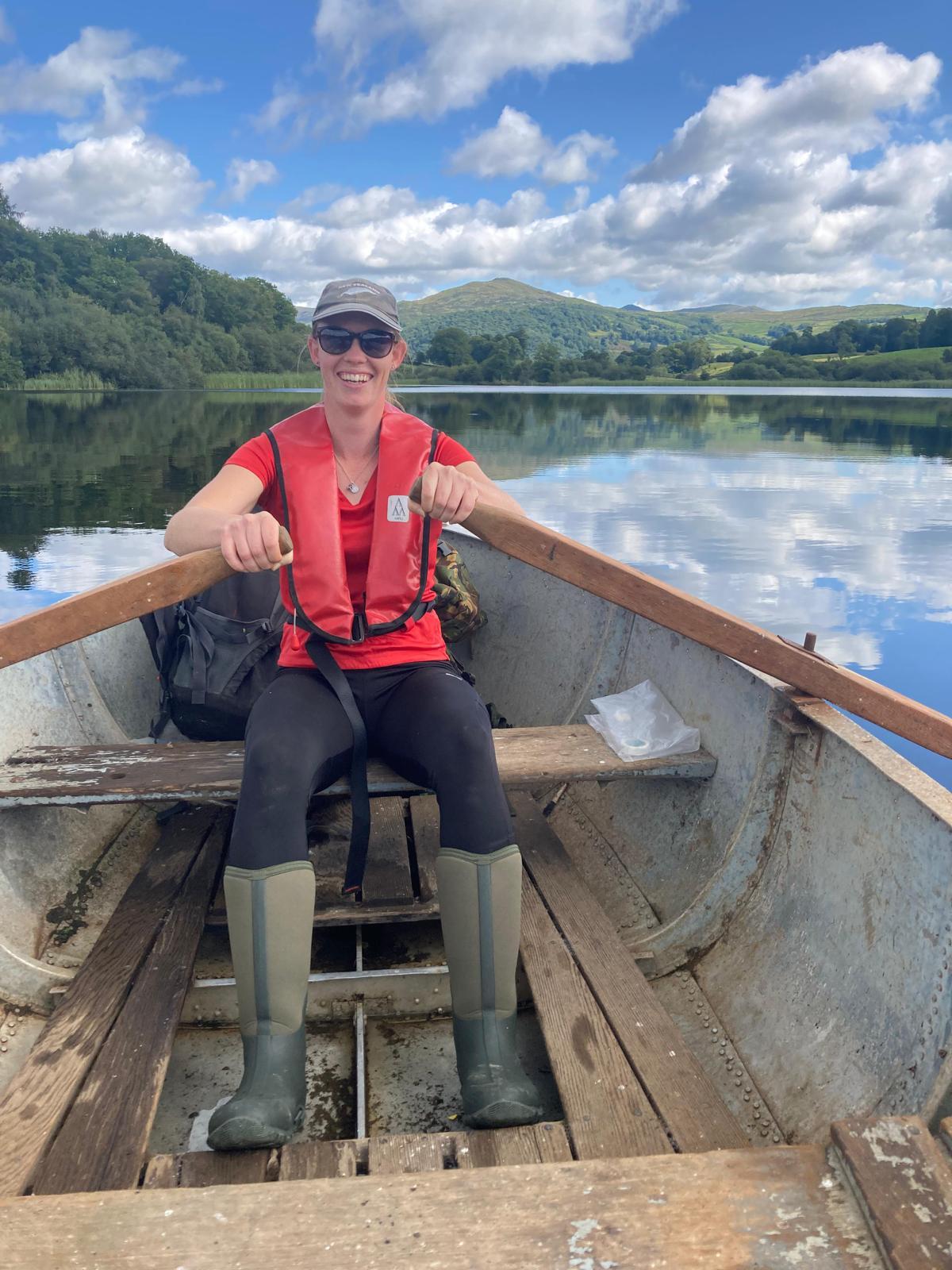 Field scientist rowing on a lake