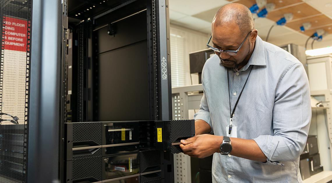 Franck Mpinda working in the UKCEH server room in Wallingford