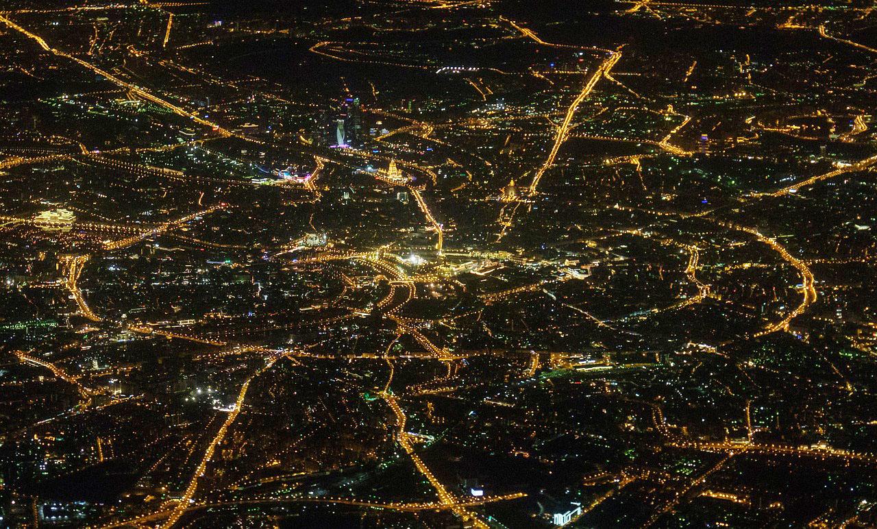 Aerial view of city at night showing streetlighting