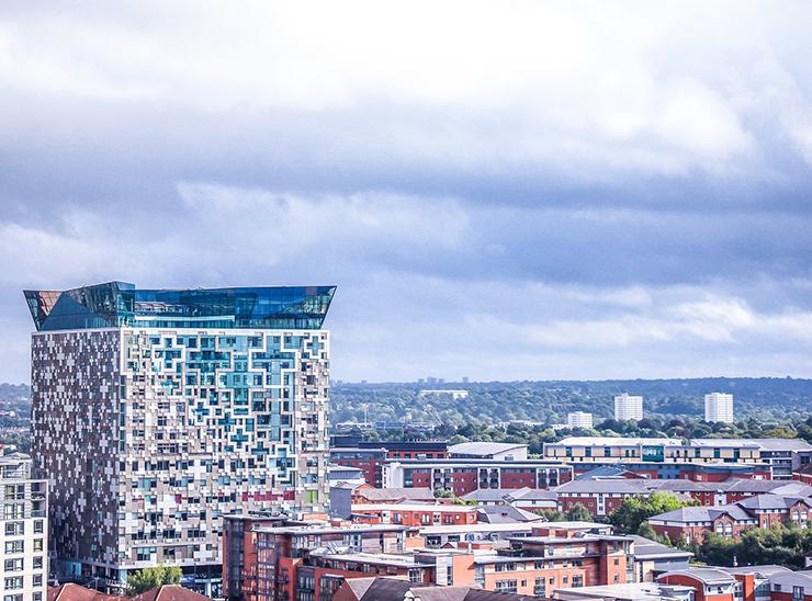 View over Birmingham city skyline with lots of trees