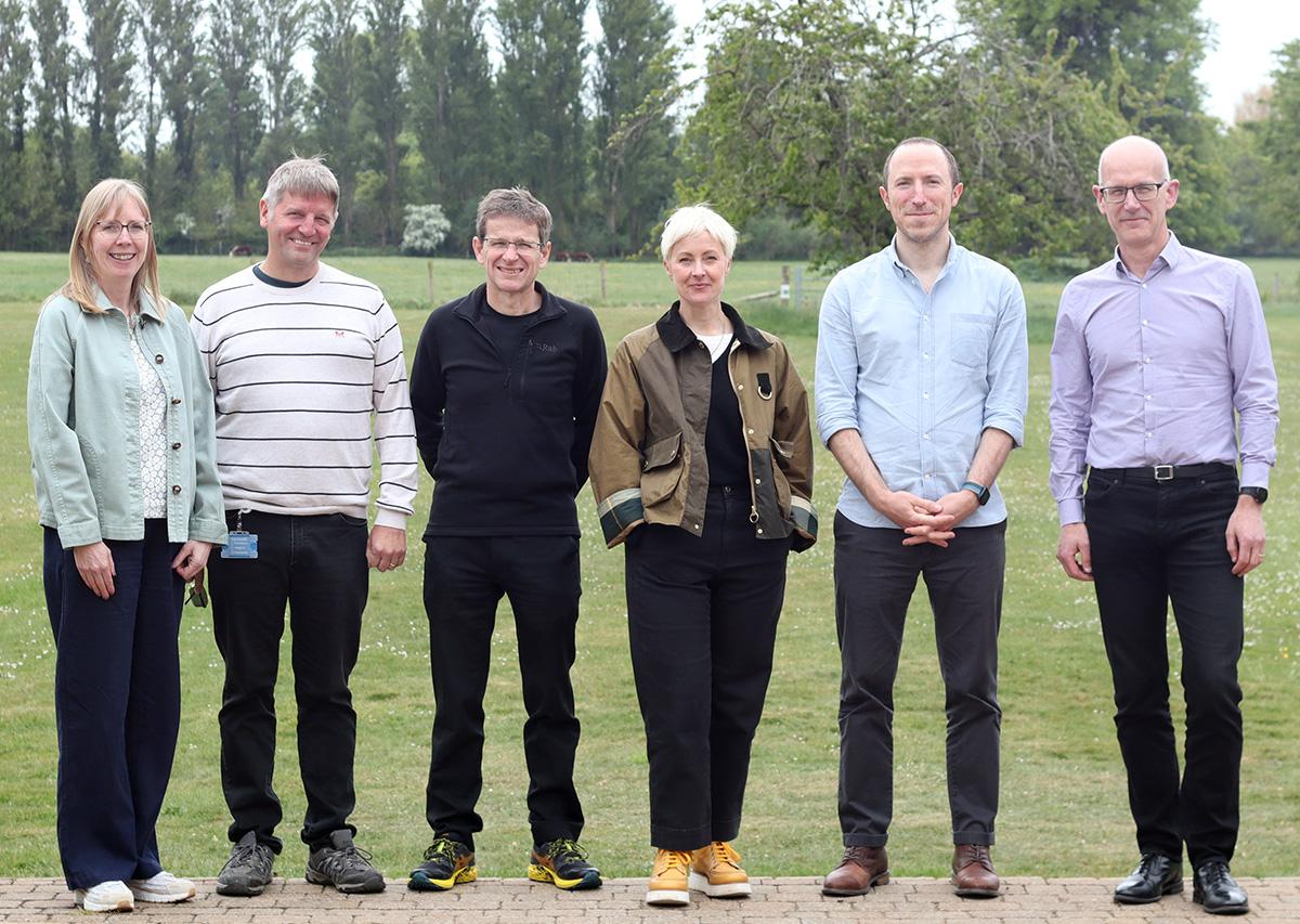Six people standing in a row