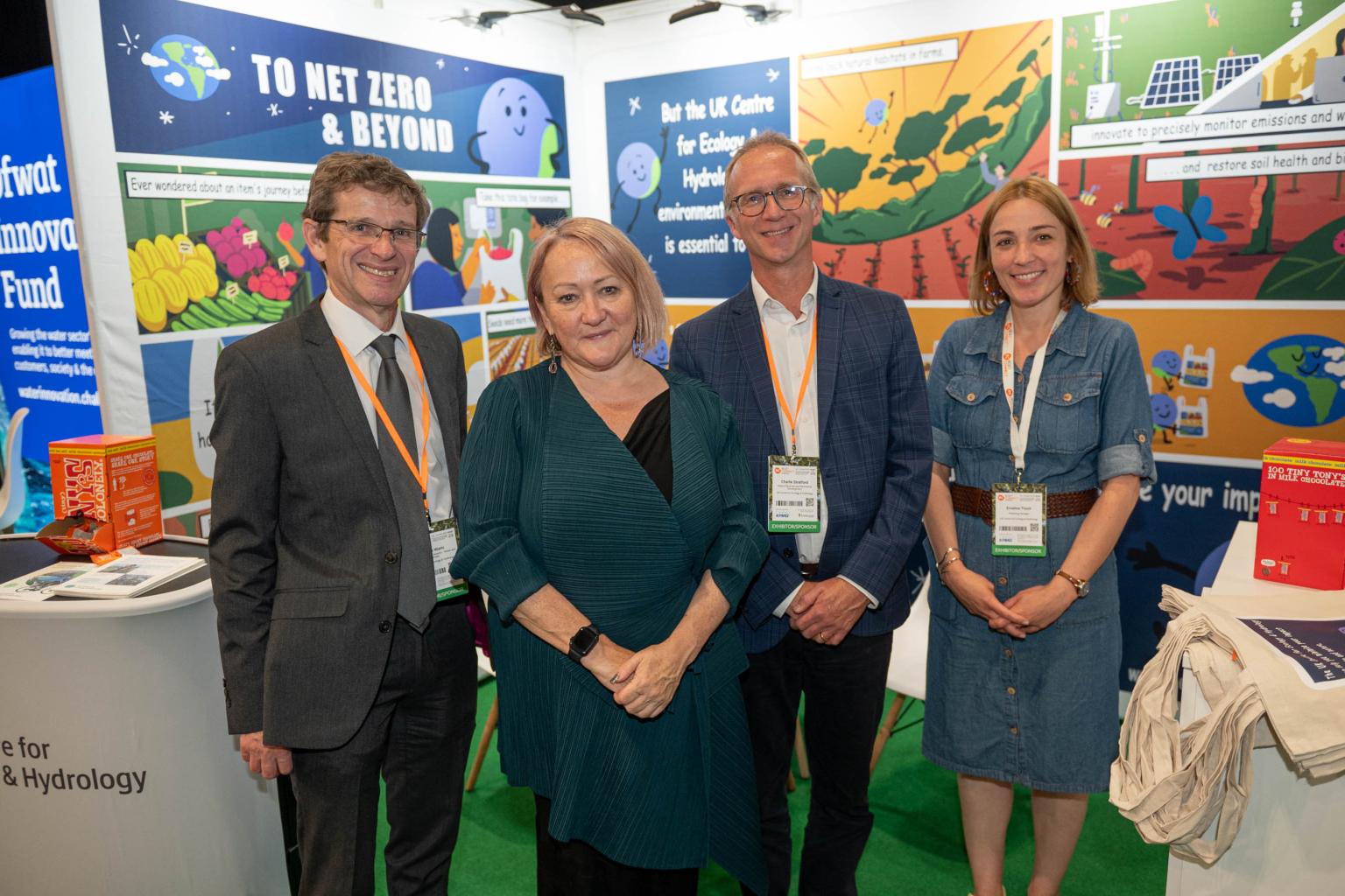 Group of four in front of an exhibition stand