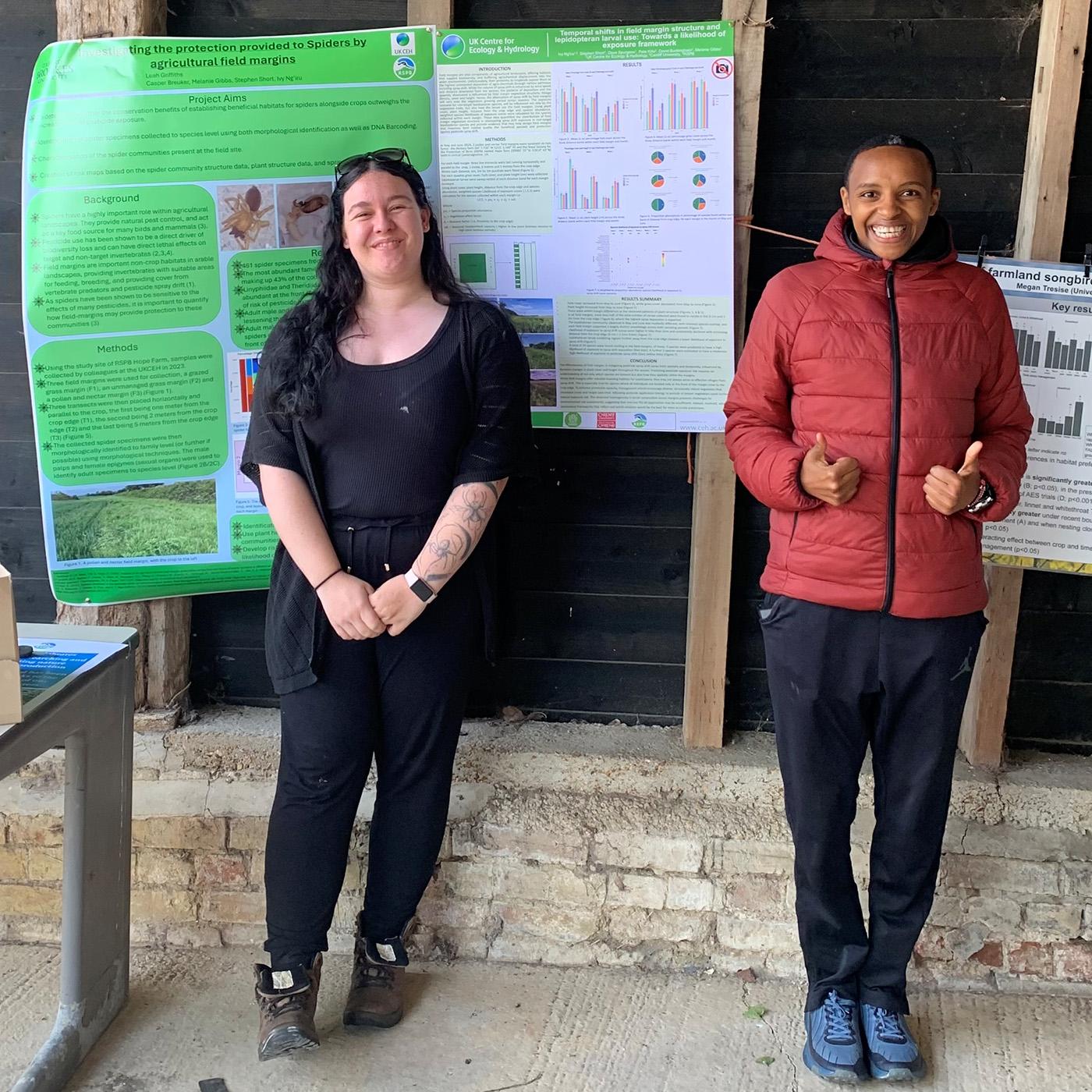 Leah and Ivy standing in front of some scientific posters