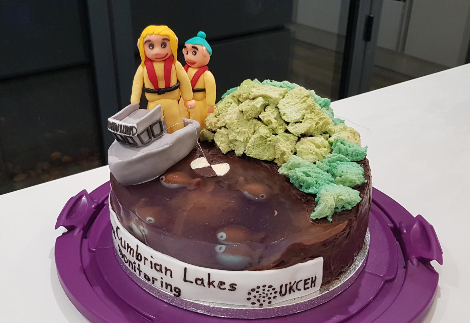 A cake with iced people and a boat celebrate Cumbrian lakes monitoring
