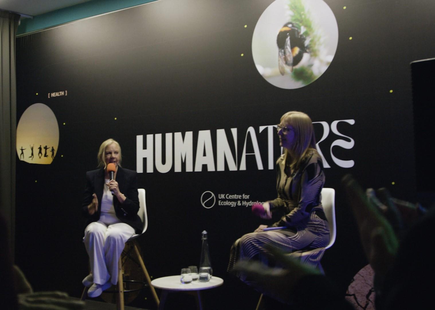 Two people talking on a stage