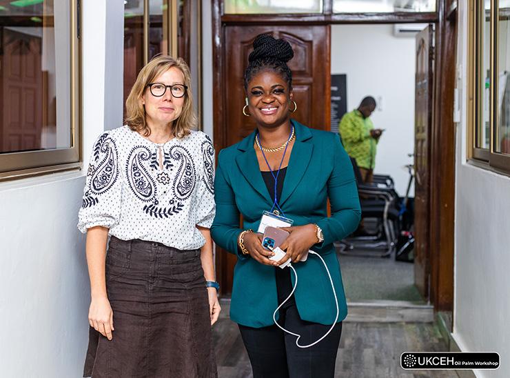 Two women stand side-by-side in a corridor