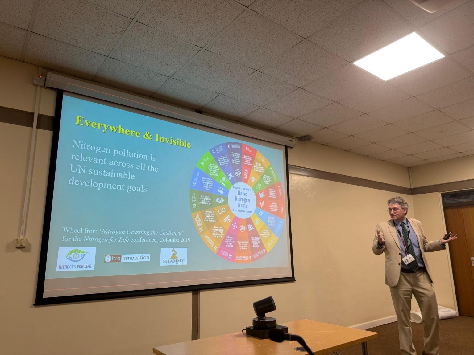 Man presenting in front of a screen