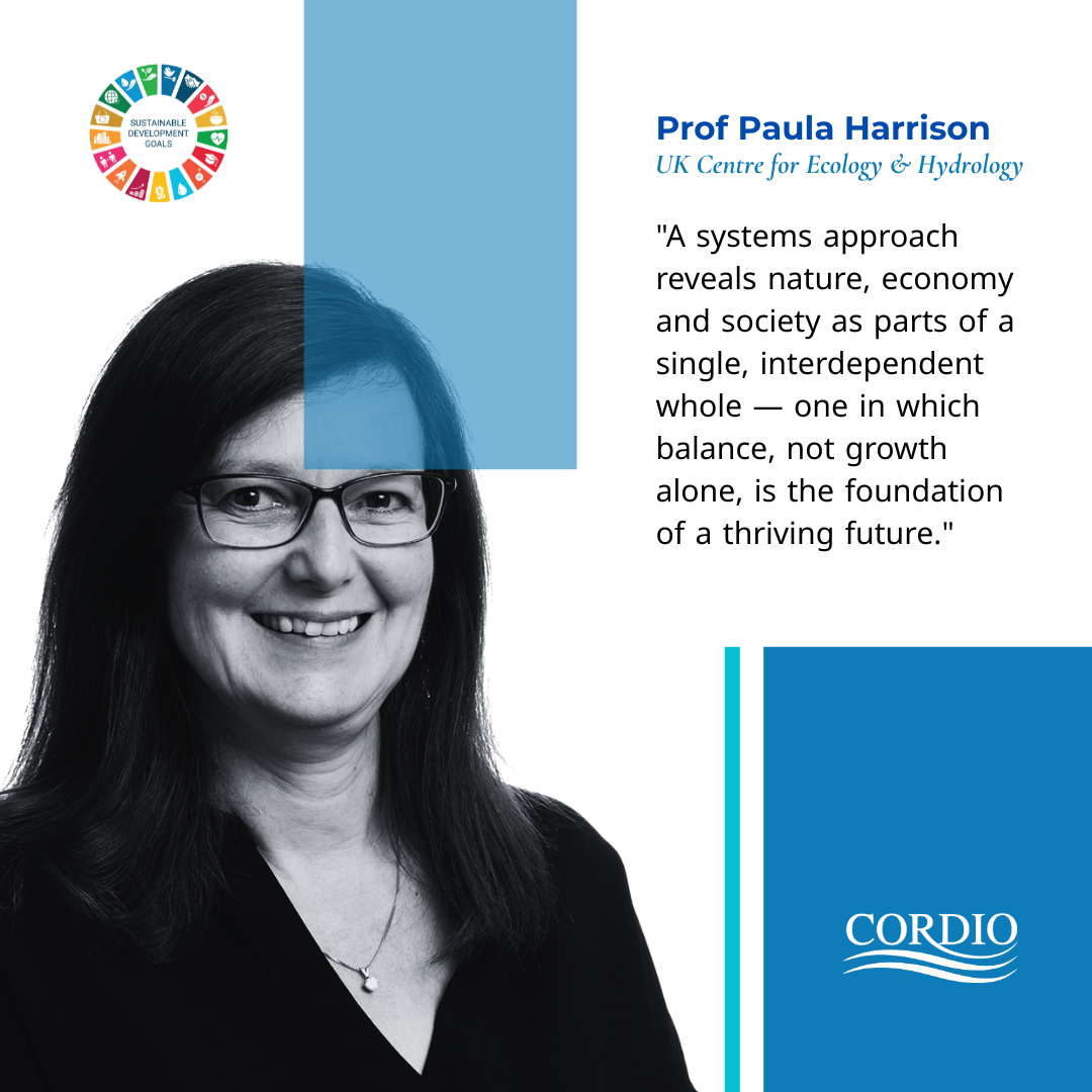 Prof Paula Harrison and the Sustainable Development Goal wheel, with the quote A systems approach reveals nature, economy and society as parts of a single, interdependent whole - one in which balance, not growth alone, is the foundation of a thriving future"