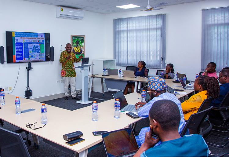 Person at lectern presenting to a room of people