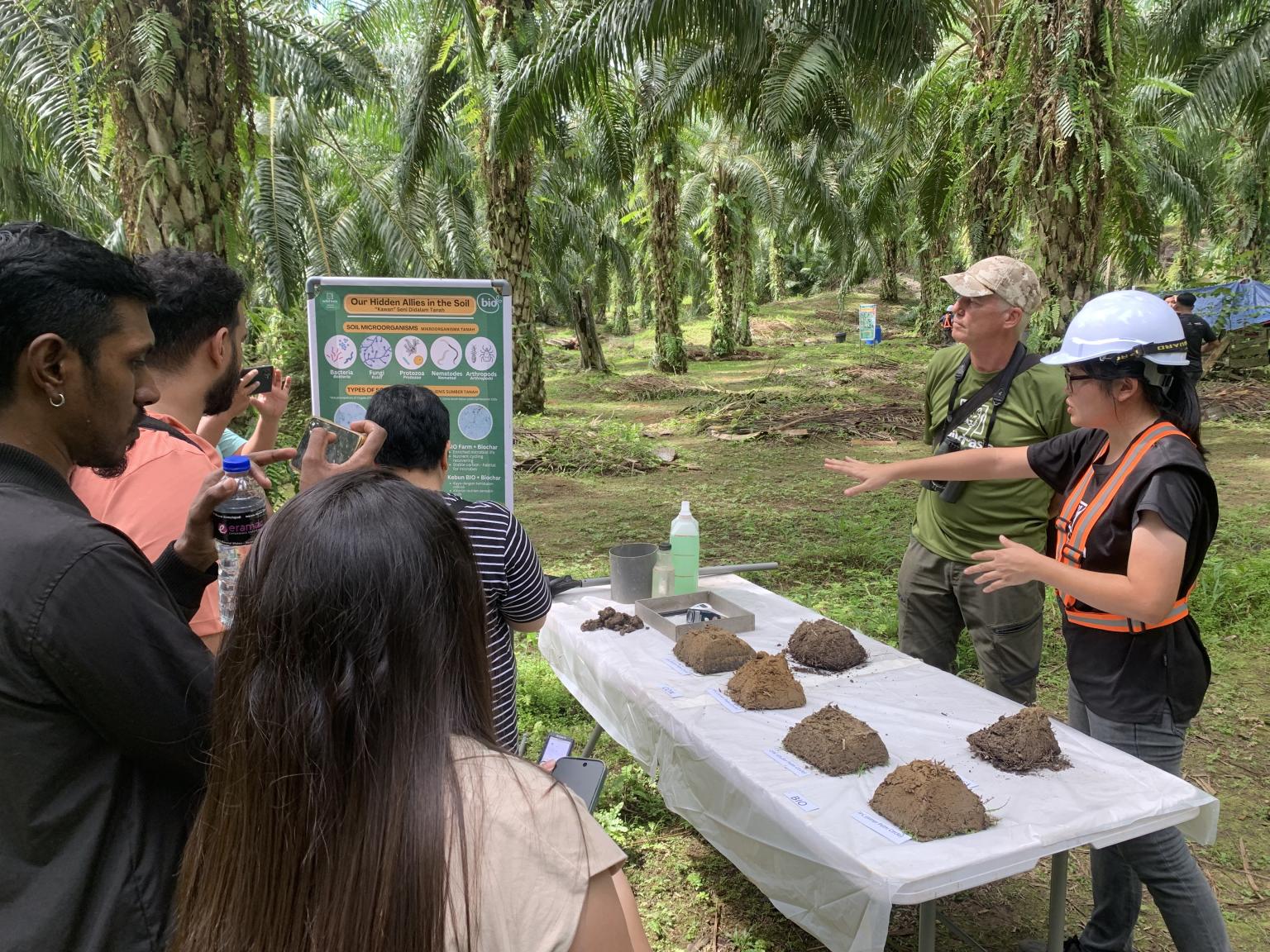 People looking at soil types on a table