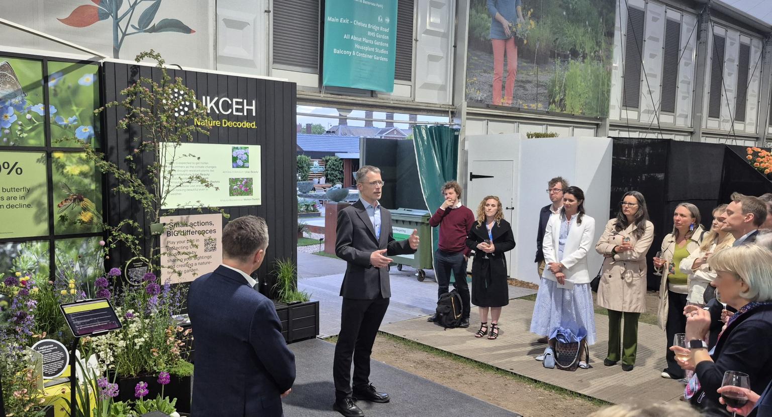 Person addressing an audience in front of a display