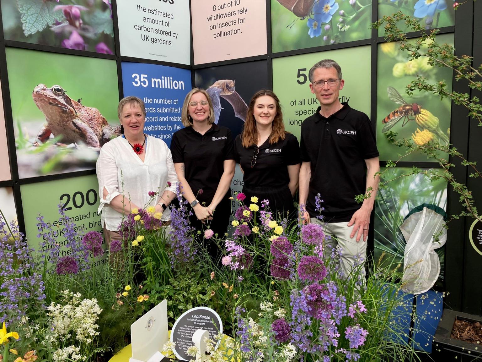 Four people standing in front of a display
