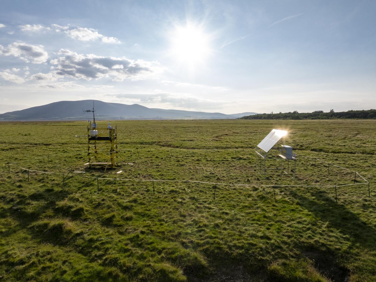 Flux tower on a saltmarsh with sun in the sky