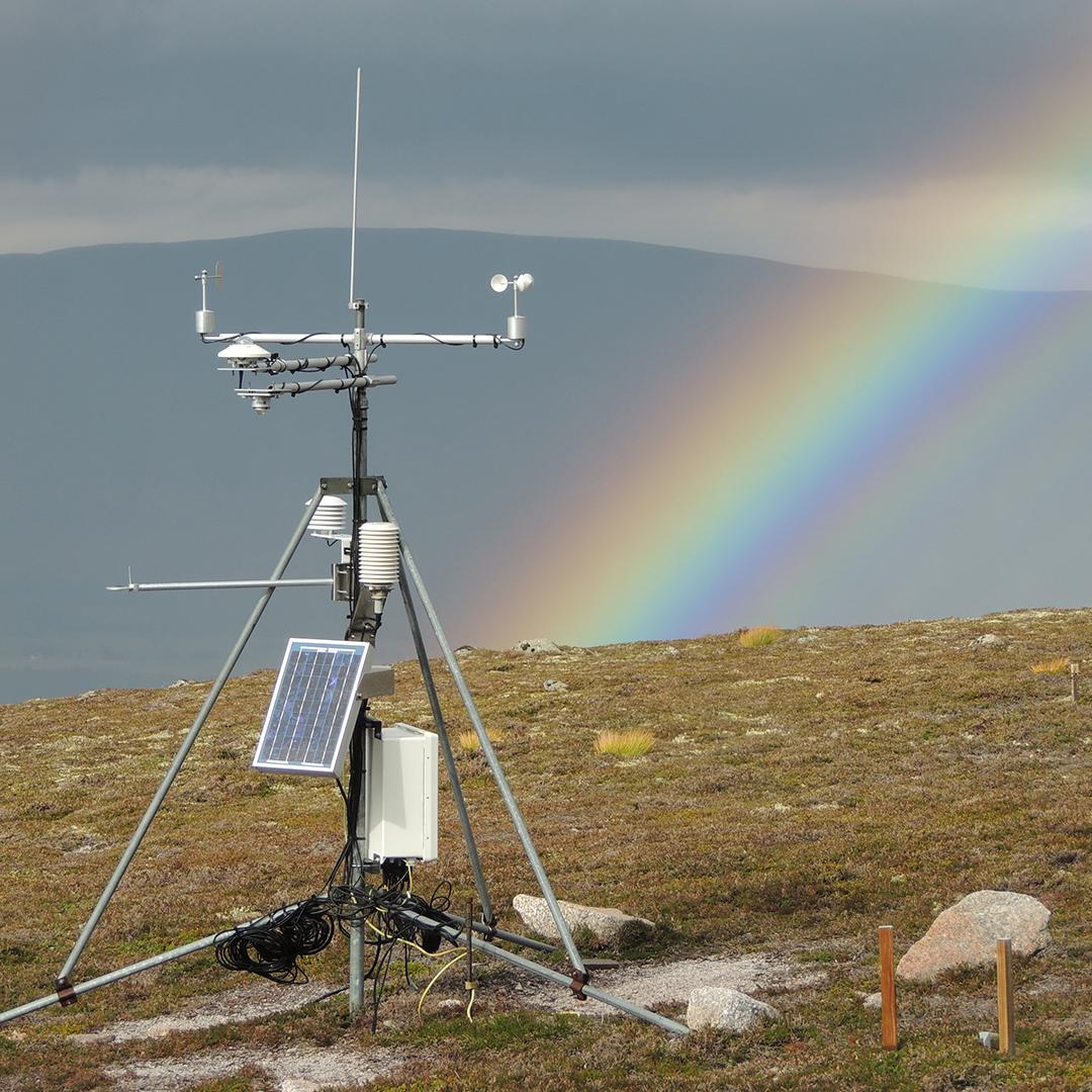 An Automatic Weather Station in the Cairngorms, with a rainbow behind