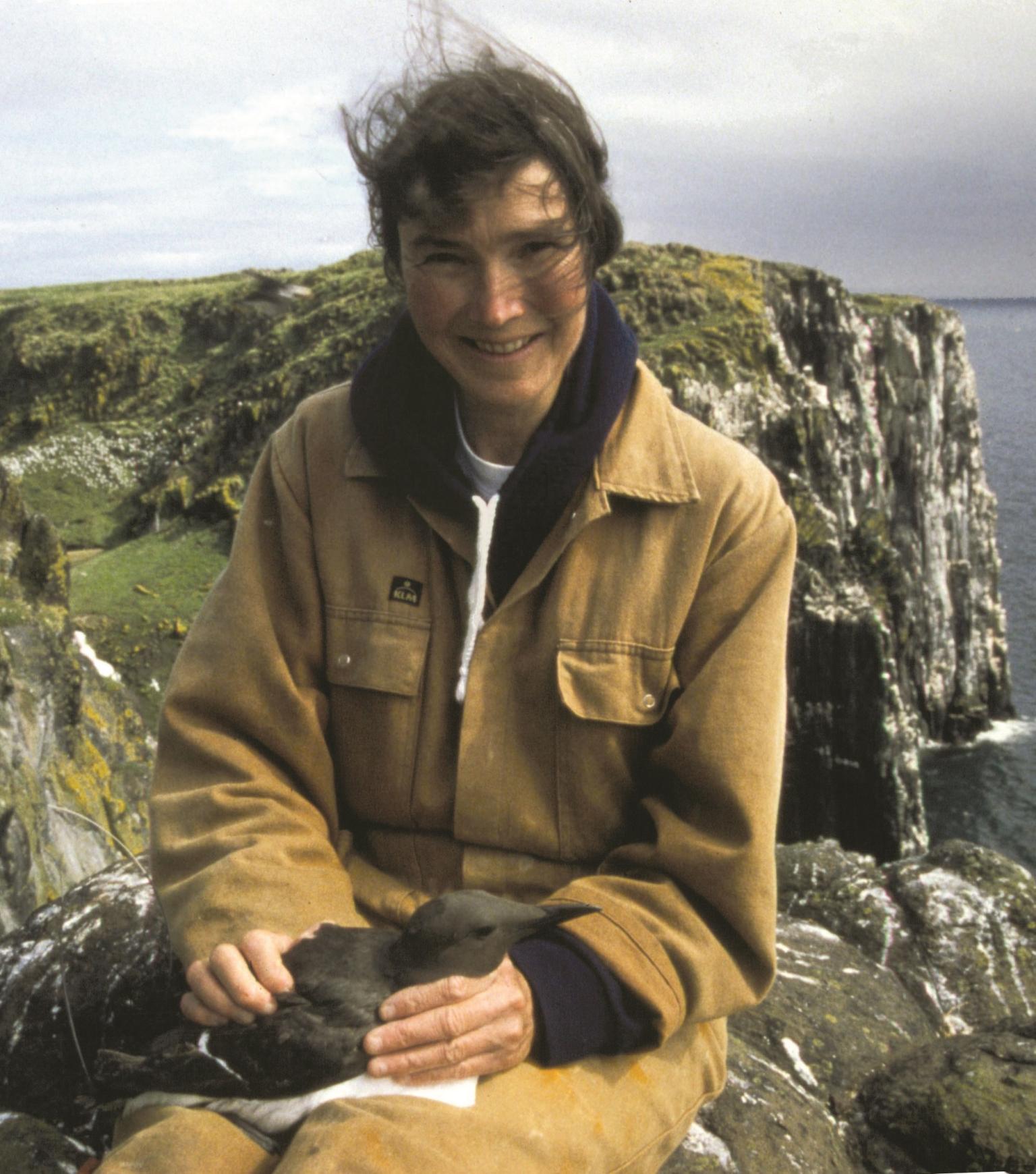CEH ecologist Sarah Wanless on the Isle of May with a common guillemot