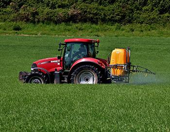 Tractor spraying insecticide