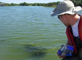 Scientist photographing algae on Loch Flemington