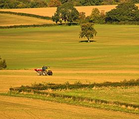 A tractor on farmland with hedgerows   Picture: Shutterstock