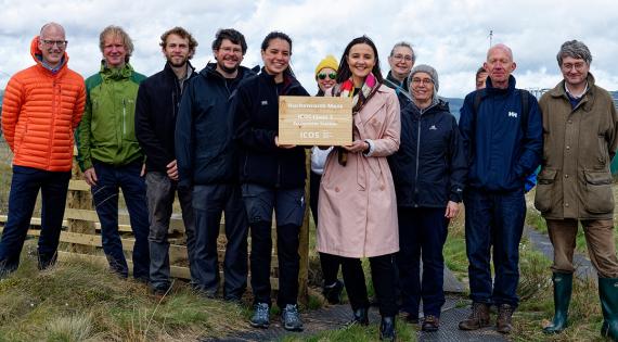 Presenting a plaque with a group of people