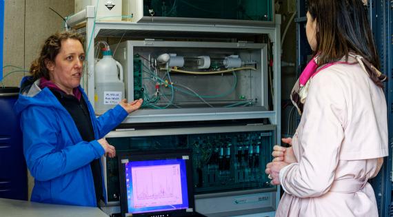 Person showing scientific equipment to another person