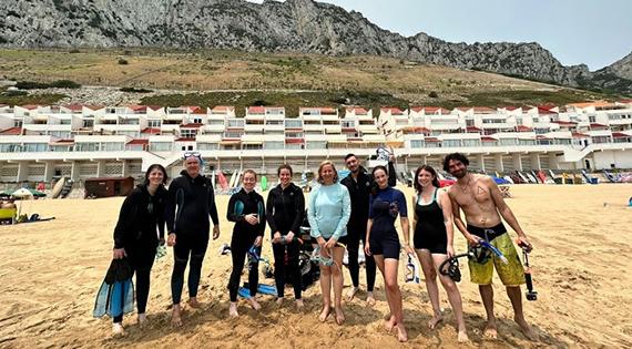 Group with snorkeling gear on Sandy Beach, Gilbraltar