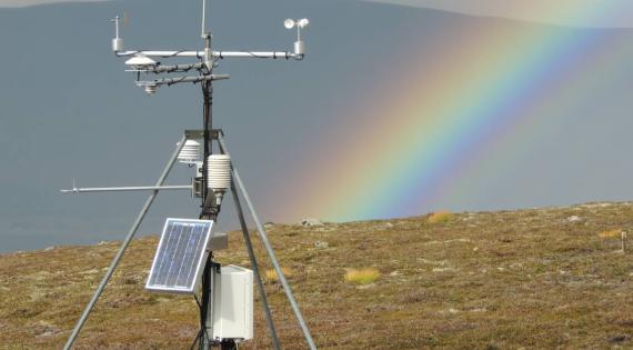 ECN field equipment with a rainbow in background
