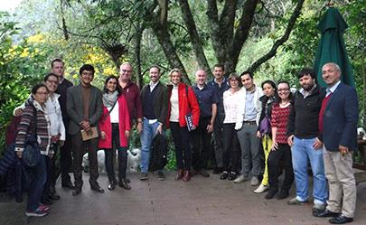 Group of researchers standing by a tree
