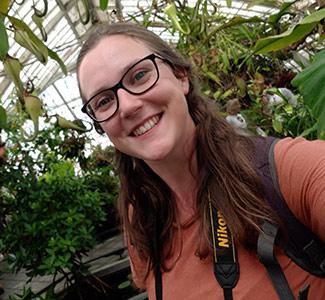 Woman in a large greenhouse