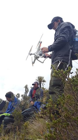 Prepping the drone Man holding a drone