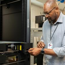 Franck Mpinda working in the UKCEH server room in Wallingford