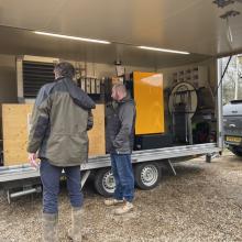 Couple of people in front of a trailer