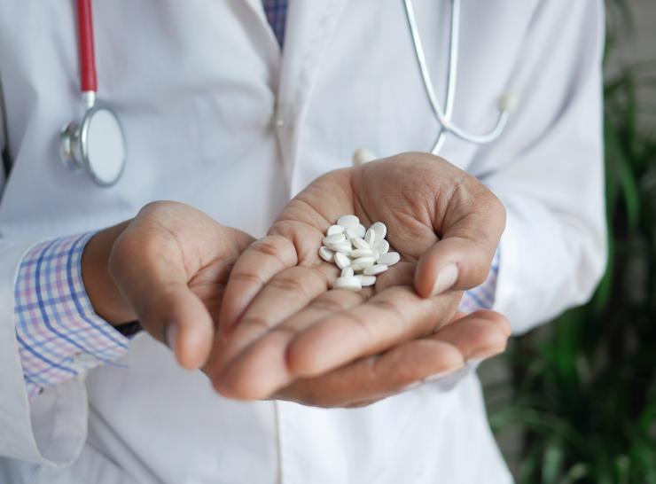 Doctor holding pills in hands