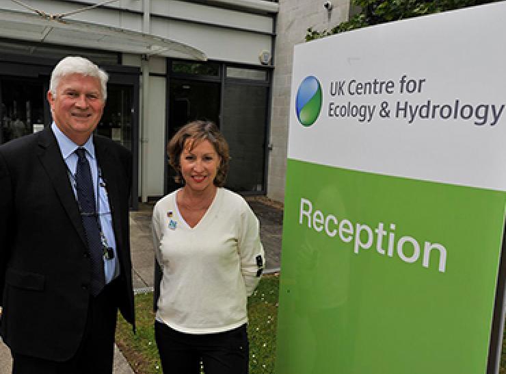 Two people standing beside a reception sign