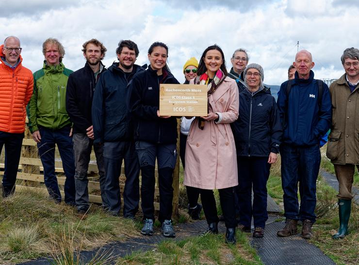 Presenting a plaque with a group of people