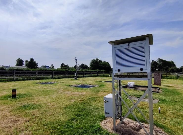 Stevenson screen and rain gauges at meteorological observing station