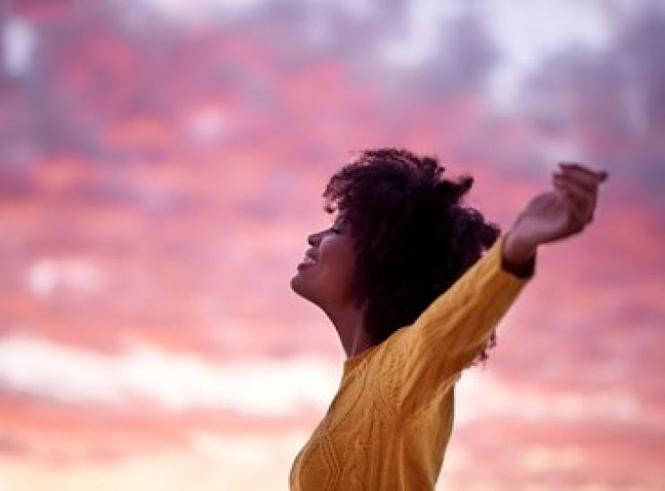 Woman stretching arms out happily