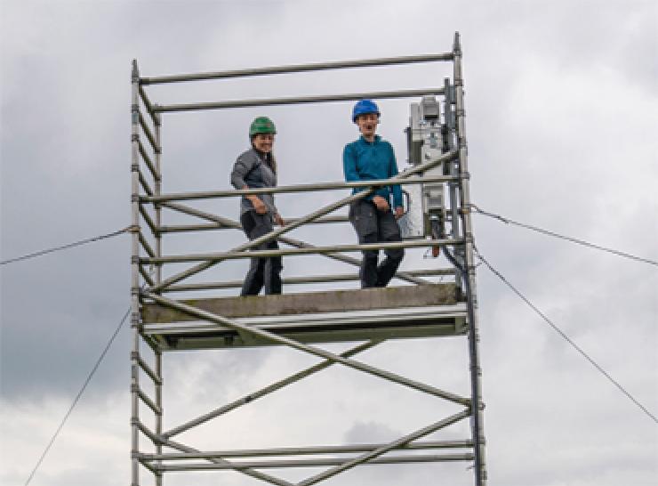 People standing on scaffolding tower